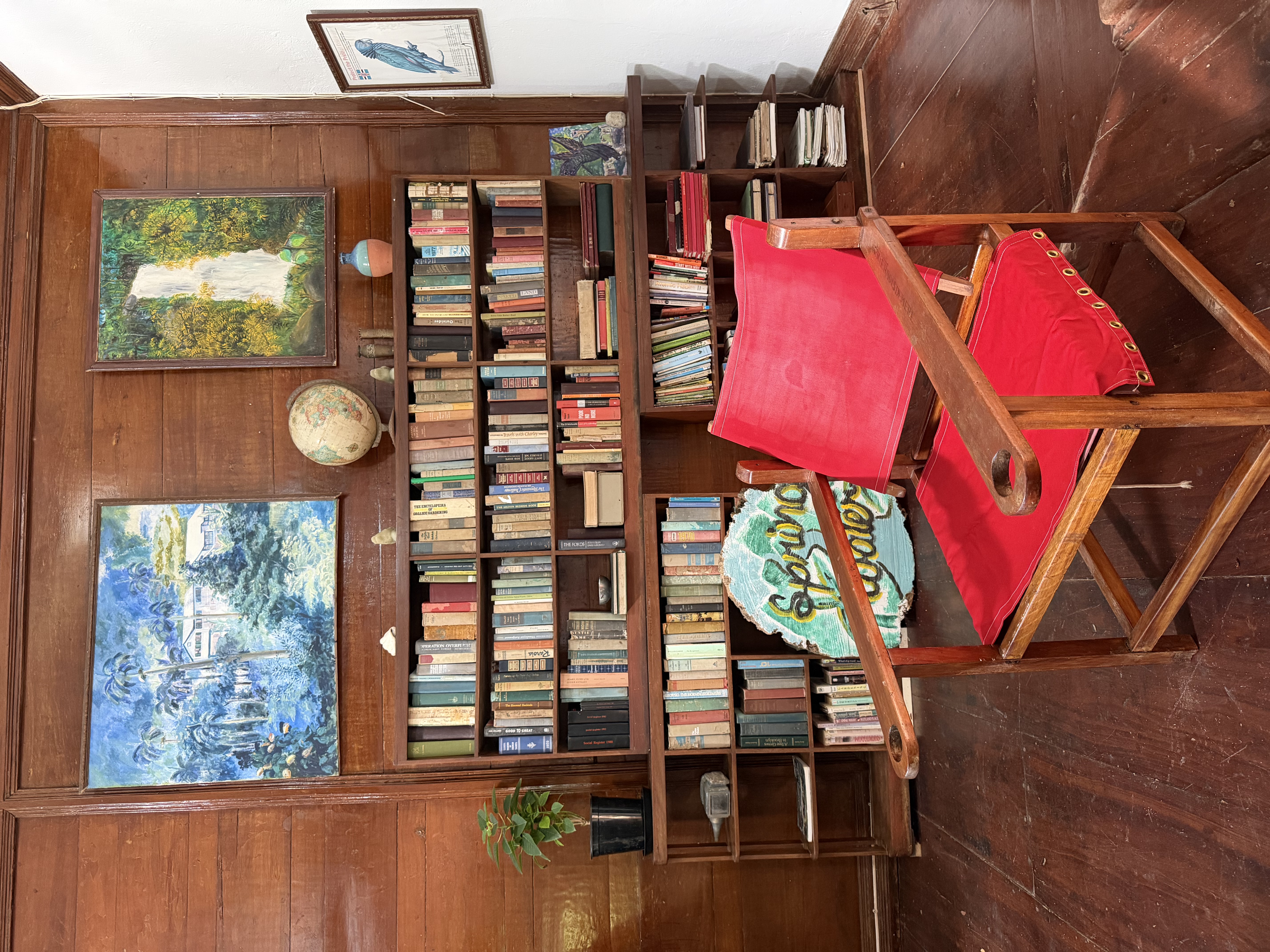 Springfield House library with art, books, and red chair